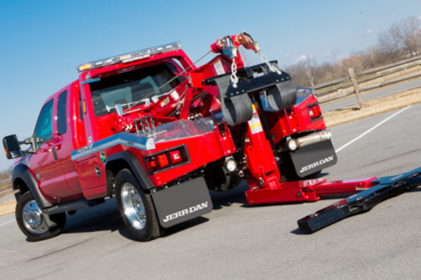 Flatbed tow truck providing 24/7 towing service on a New Jersey highway with immediate dispatch