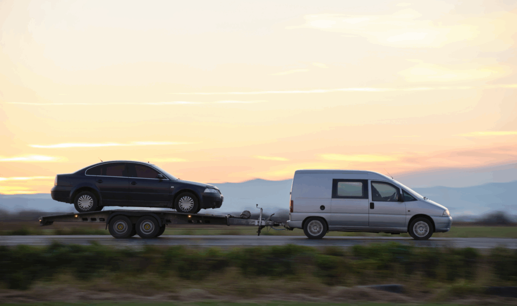 Flatbed tow truck from Polina Transporter LLC loading an all-wheel-drive low-clearance luxury car in New Jersey for safe vehicle recovery