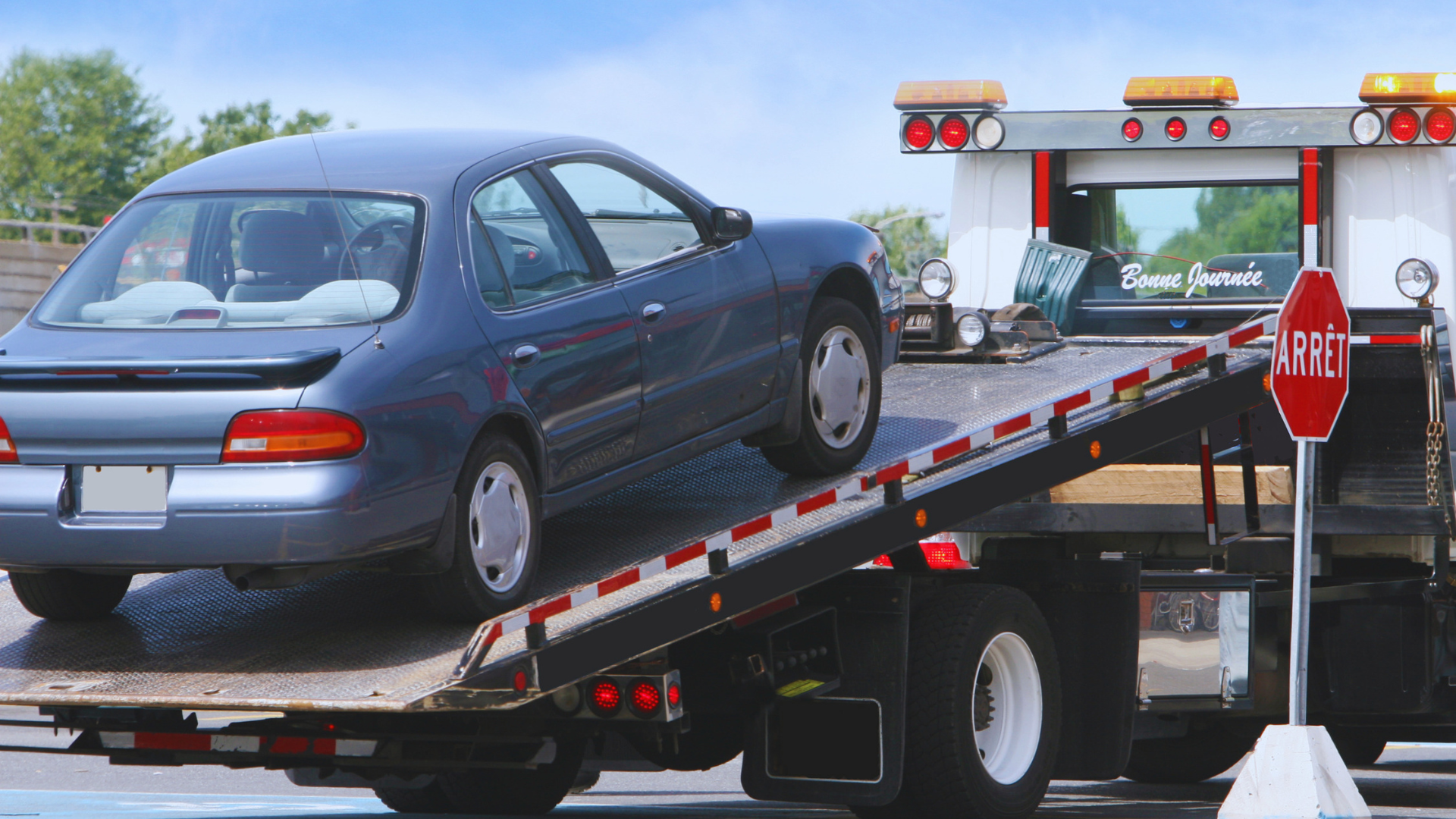 Flatbed tow truck providing New Jersey towing services.